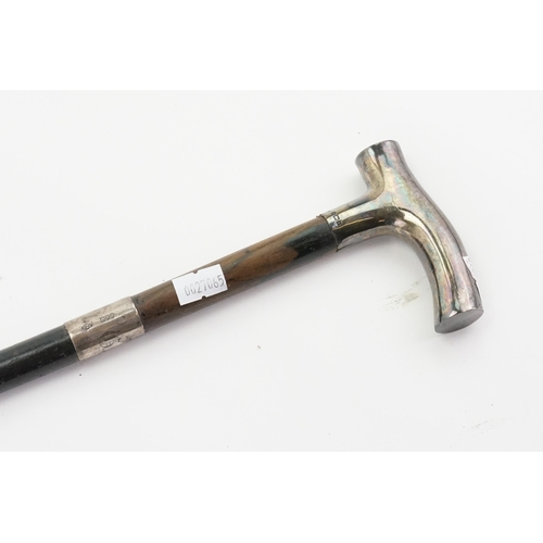 283 - A Victorian Walking Stick with a Shaped Silver Handle.