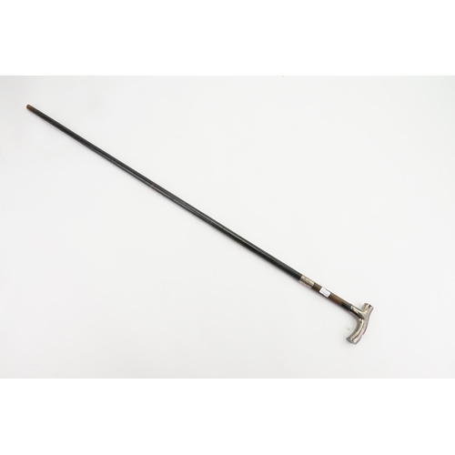 283 - A Victorian Walking Stick with a Shaped Silver Handle.