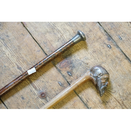 285 - A Silver Topped Walking Stick on a Tortoise Shell effect mount & one other designed as a French Monk... 