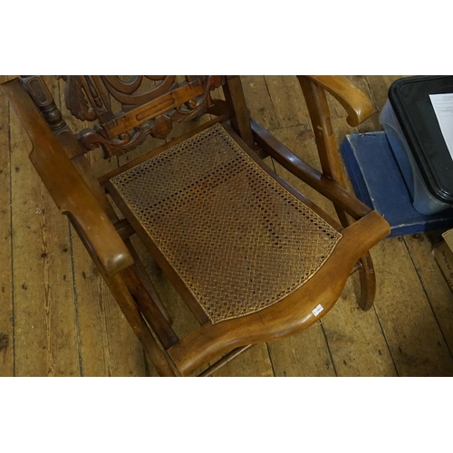 438 - A Victorian Walnut Framed Pierced & Carved Back Fold-Up Coaching Chair with a Cane Seat.