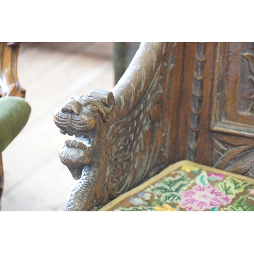 430 - A Late 19th Century Carved Oak Monk's Bench with a pierced Scroll Top & Lions End Mounts. Measuring:... 