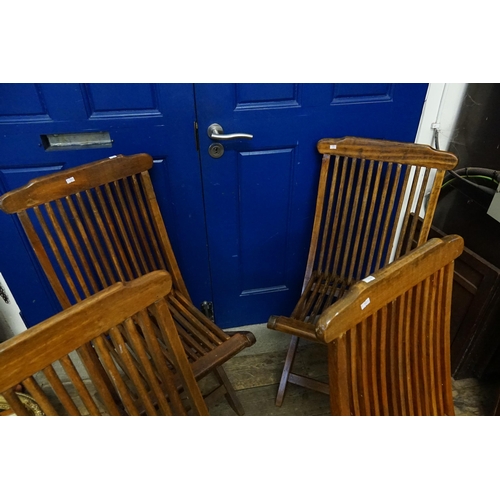 698 - A Set of Four Fold-Up Slat Backed Garden Chairs.