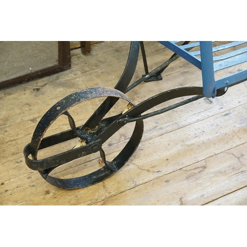 699 - A Regency design Wrought Iron Wheel Barrow Garden Chair in Blue & Black. Measuring: 184cms long.