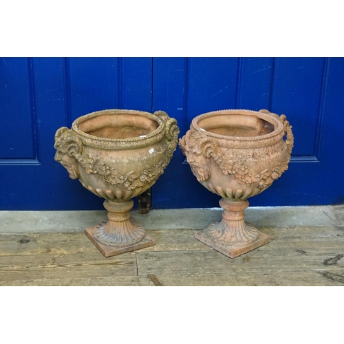 703 - A Pair of Terracotta Effect Twin Headed Bacchus decorated Garden Erns with Floral Festoons & Square ... 