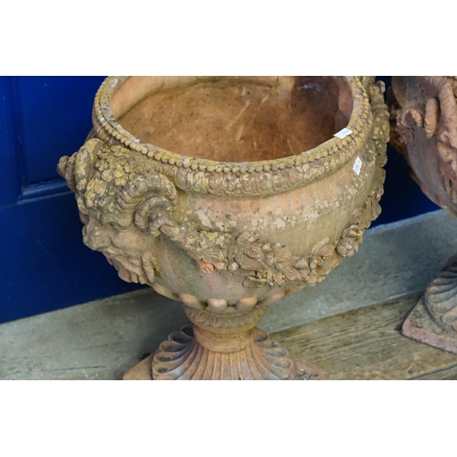 703 - A Pair of Terracotta Effect Twin Headed Bacchus decorated Garden Erns with Floral Festoons & Square ... 