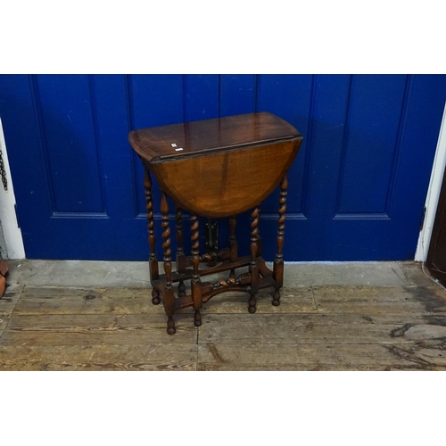 454 - A 1920s Oak Drop-Flap Table. Measuring: 52cms long x 25cms. (Closed).