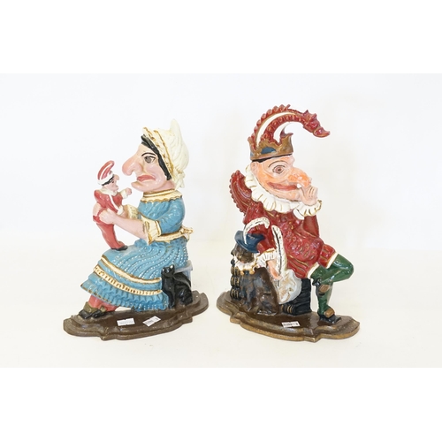 737 - A Pair of Mr. & Mrs. Punch & Judy Cast Iron Door Stops with painted decoration.