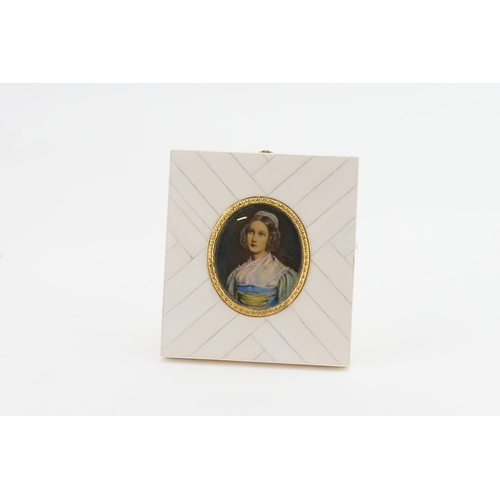 589 - A Portrait of a Young Girl in a Blue Dress in a Gilt Metal Frame.