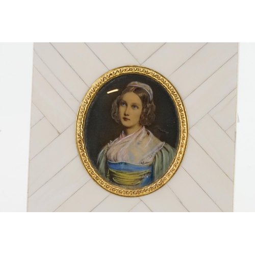 589 - A Portrait of a Young Girl in a Blue Dress in a Gilt Metal Frame.