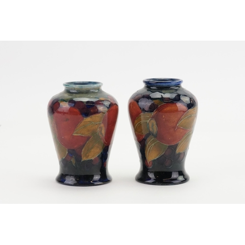 664 - A Pair of Moorcroft Pomegranate Bulbous Vases decorated in Puce, Blue & Red. Standing: 9cms high.