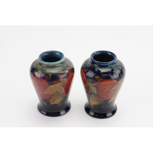 664 - A Pair of Moorcroft Pomegranate Bulbous Vases decorated in Puce, Blue & Red. Standing: 9cms high.