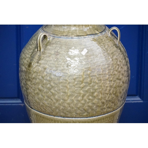 510 - A Celadon Glazed Three Handled Lug Storage Jar. Measuring: 70cms high.