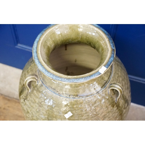 510 - A Celadon Glazed Three Handled Lug Storage Jar. Measuring: 70cms high.