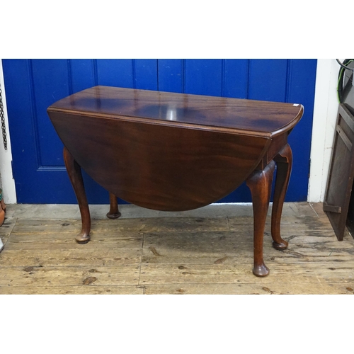 420 - A Georgian Mahogany Oval Top & Drop Flap Dining Room Table resting on a heavy Pad Foot, Pull out & S... 