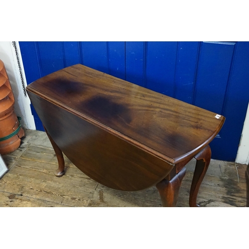 420 - A Georgian Mahogany Oval Top & Drop Flap Dining Room Table resting on a heavy Pad Foot, Pull out & S... 