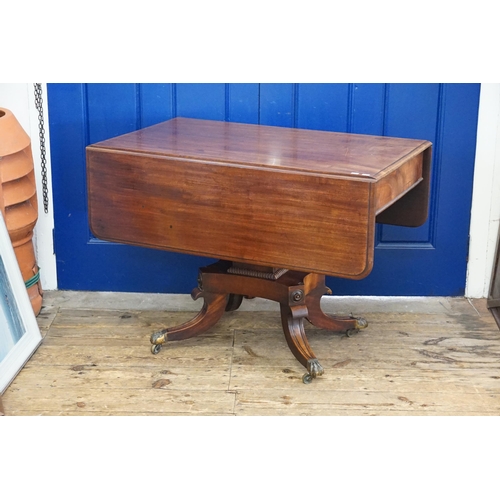 421 - A Victorian Mahogany Drop-Flap Supper Table with ogee decoration resting on a central Tripod Base wi... 