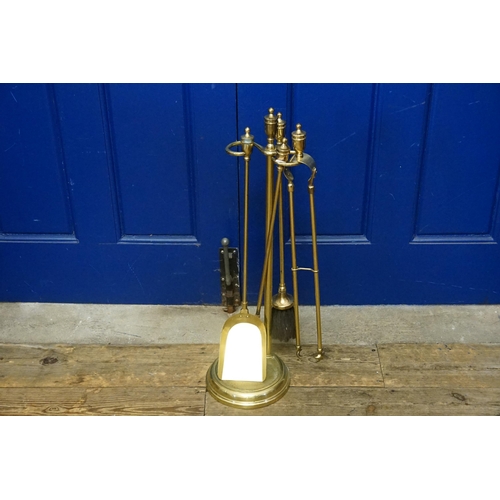 741 - A Four Piece Brass Finished Companion Set on Stand.