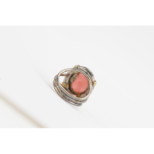 162 - A silver coloured white metal pink stone set ring. Marked 750 & 950. Weight 8.6g. Size L.