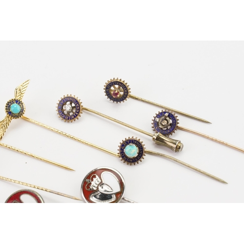 127 - A collection of gold coloured Rotary club stick pins, along with some enamelled, set with opal, diam... 