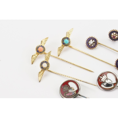 127 - A collection of gold coloured Rotary club stick pins, along with some enamelled, set with opal, diam... 