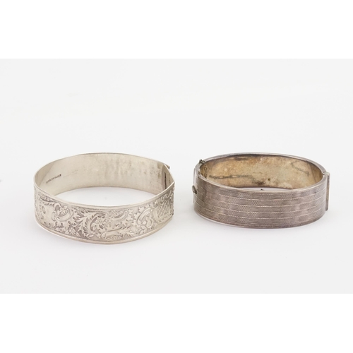 176 - Two silver engraved bangles.