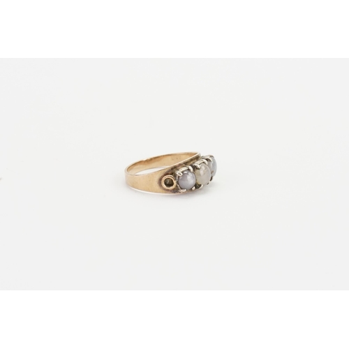 133 - A yellow gold coloured ring, set with moonstones. Weight 3.1g. Size Q.