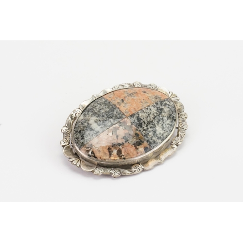 143 - A Scottish pebble brooch, in the oval formation, set with various agates. Width 6.6cm x 4.9cm.