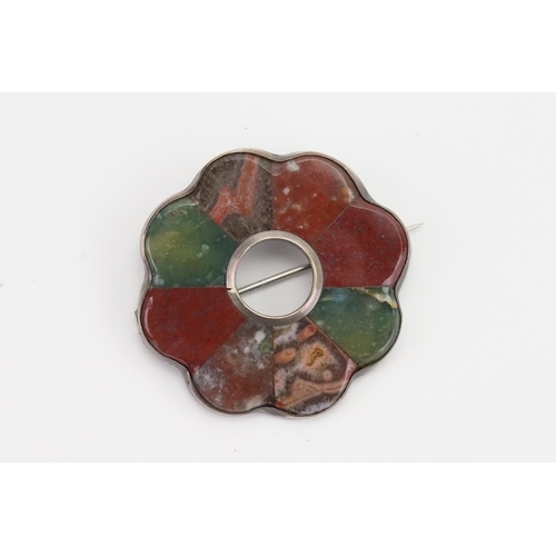 146 - A Scottish pebble brooch, set in a silver mount. Set with various agates. Diameter 4.2cm.