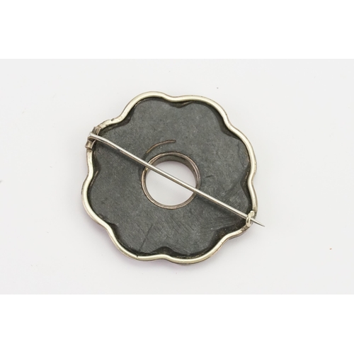 146 - A Scottish pebble brooch, set in a silver mount. Set with various agates. Diameter 4.2cm.