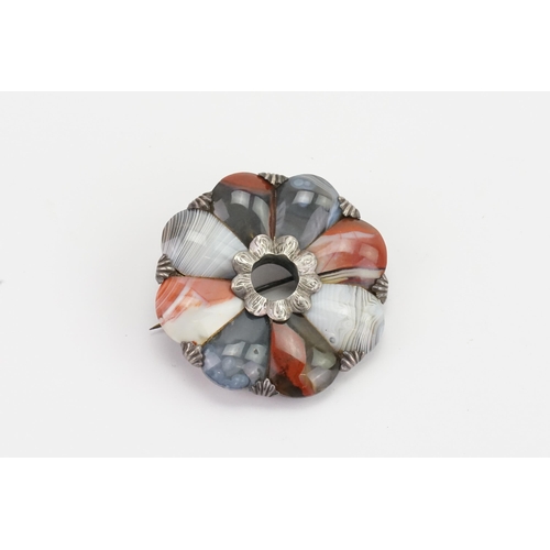 152 - A Scottish pebble brooch, set with various agates, in a silver mount with shell claws. Diameter 4.5c... 