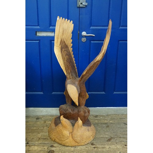 610 - A Large Carved Hardwood Study of an Eagle in Flight with Chicks. Measuring: 120cms high.