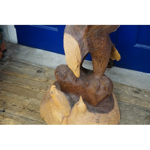 610 - A Large Carved Hardwood Study of an Eagle in Flight with Chicks. Measuring: 120cms high.