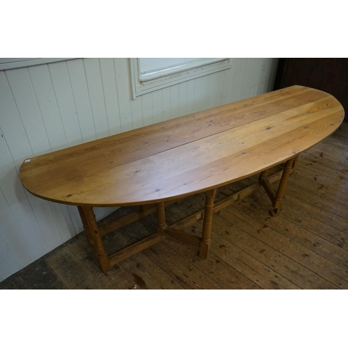 551 - An 19th Century design Irish Pine Wake Table with Fold-Out Bulbous Flaps & Square Cross Stretchers i... 