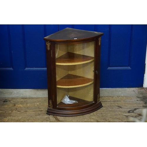 586 - A Stained as Beech Bow Fronted Glass Display Cabinet with metal mounts. Measuring: 49cms across x 34... 