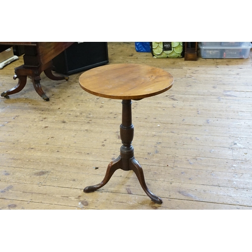 589 - A circular top tilt top wine table.