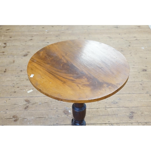 589 - A circular top tilt top wine table.