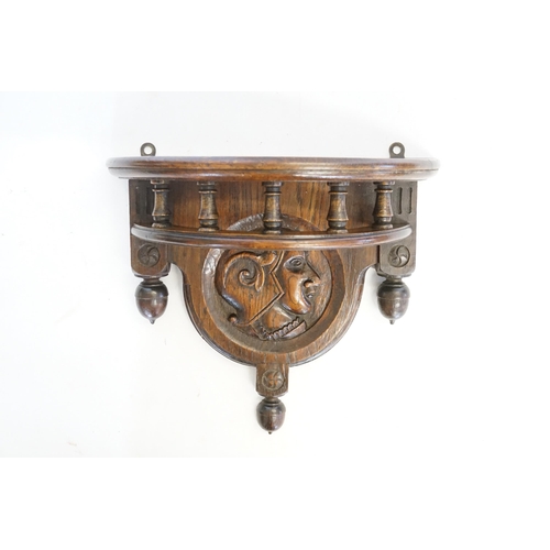 605 - An Antique carved Oak Clock Bracket with turned & acorn decoration carved with a Roman Soldier. Meas... 