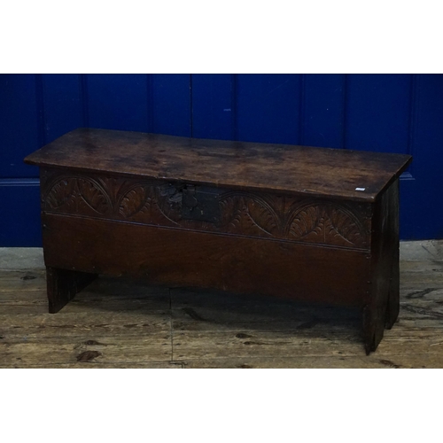 606 - An Antique Oak Four panelled Coffer with a half carved front. Measuring: 99cms across x 34cms deep x... 