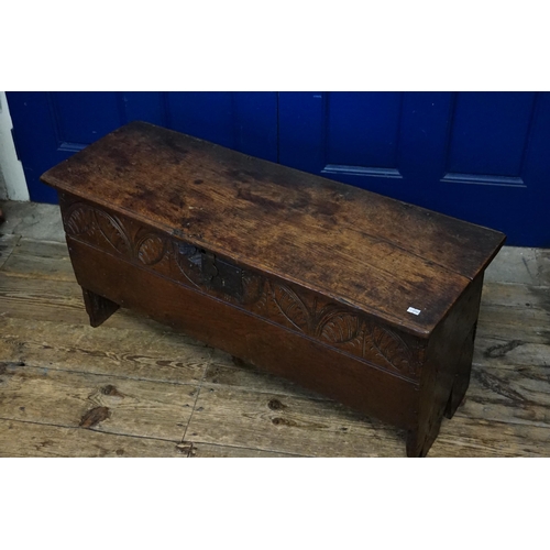 606 - An Antique Oak Four panelled Coffer with a half carved front. Measuring: 99cms across x 34cms deep x... 