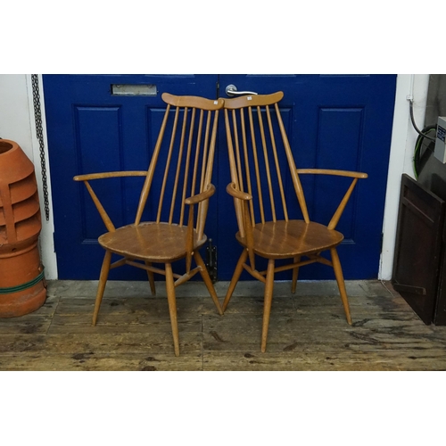 608 - A Pair of Ercol Stick Back Wide Seated Elbow Chairs.