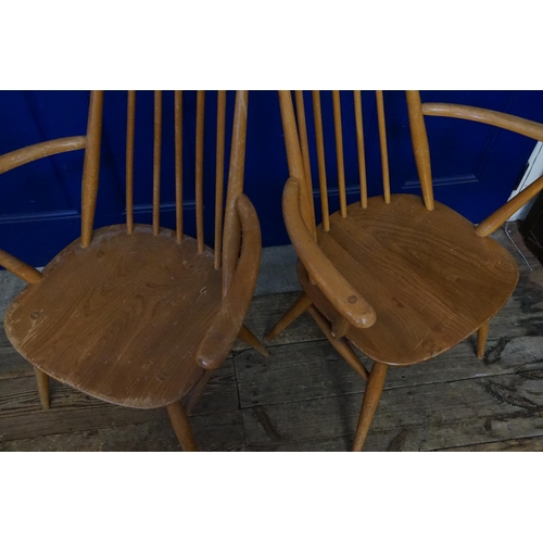 608 - A Pair of Ercol Stick Back Wide Seated Elbow Chairs.