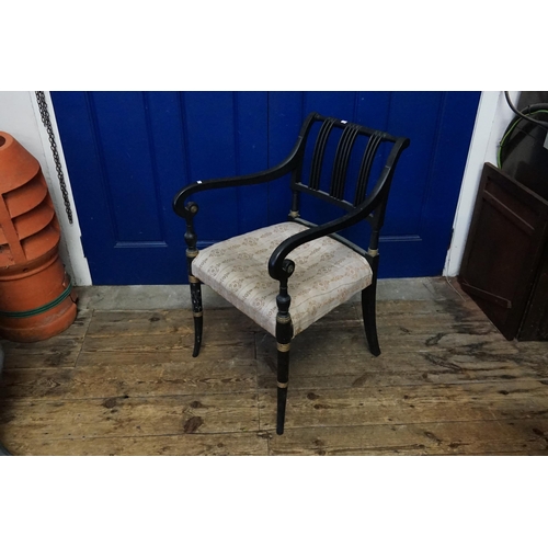 626 - A Regency design Black painted Elbow Chair with a splated back, gold decoration, swan neck arms & tu... 