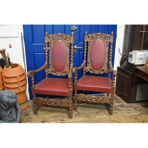 628 - A Pair of oak framed Carolean designed Elbow Chairs decorated with cupids & Vases, Barley Twist Supp... 