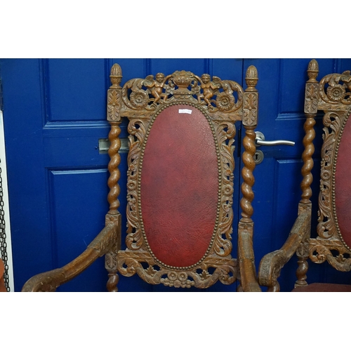 628 - A Pair of oak framed Carolean designed Elbow Chairs decorated with cupids & Vases, Barley Twist Supp... 