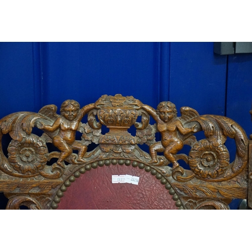 628 - A Pair of oak framed Carolean designed Elbow Chairs decorated with cupids & Vases, Barley Twist Supp... 