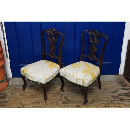 642 - A Pair of Mahogany Carved Back & Rococo pierced decoration Chairs resting on shaped legs & covered i... 