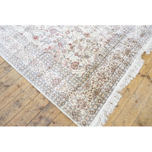 668 - A Beige Silk Carpet. Measures 245cm x 310cm.