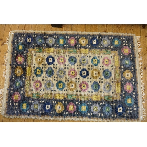 671 - A Continental Handmade Woollen Rug with Fringe, Blue Border & Flower. Measuring: 152cms x 101cms.