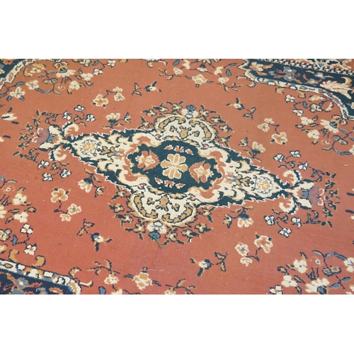 673 - An All Over Pink Ground Central Medallion Blue Cornered Rug. Measuring: 230cms x 170cms.