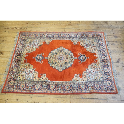 675 - A Rust Ground Central Medallion Canopy edged & Twin Gul Wide Blue Bordered Fringed Carpet. Measuring... 